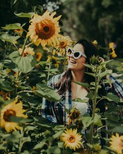 bookabin-youg-woman-sunglasses-sunflowers-australia