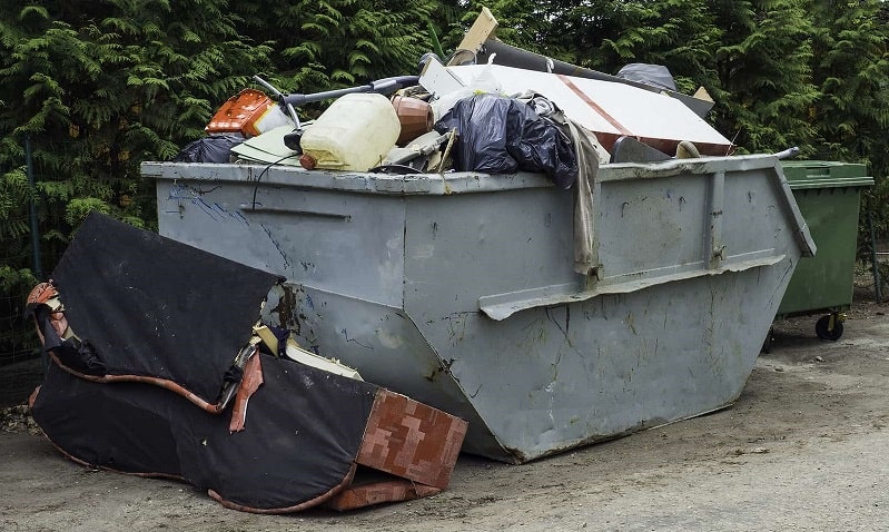 skip bin filled with garbage and overflowing