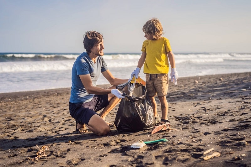 Father and Son Picking Up Rubbish in Community Clean-Up