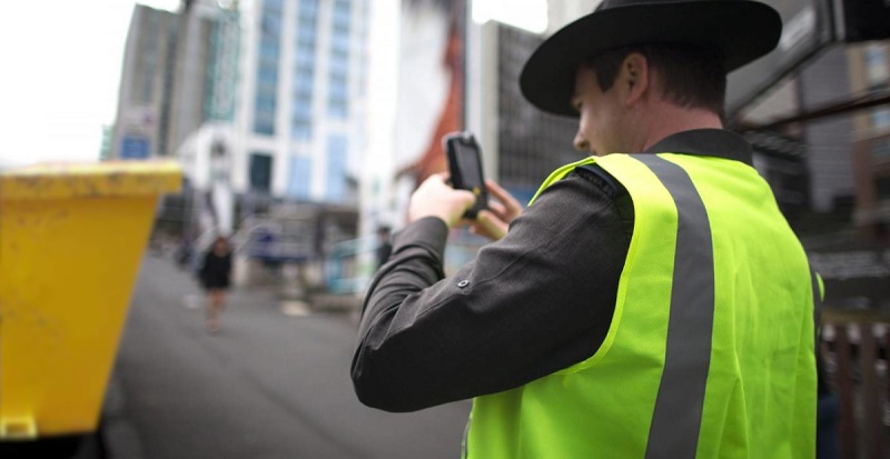 Parking-warden-photographing-skip-bin